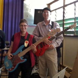 Dale and me with our new electric guitars. I think the red plate is hideous on the blue guitar...I hope to paint it a pearly white someday. But I'm really happy to have a 5-string!